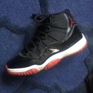 Black and red and white Jordan 11’s